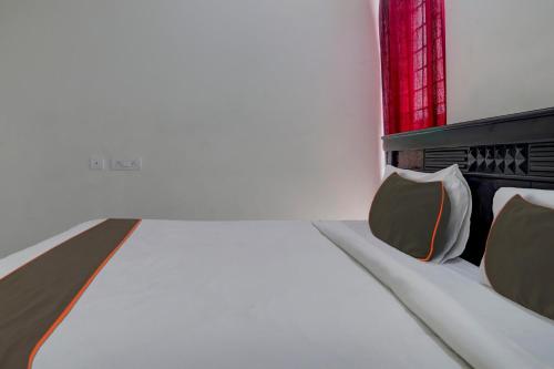 a room with a bed with two chairs and a window at Super Collection O Manikonda in Hyderabad