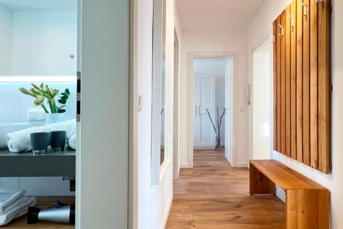 a hallway with a wooden bench in a room at Aesten Mare Kühlungsborn Apartment 2 in Kühlungsborn