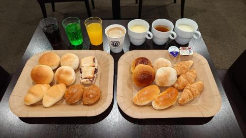 two trays of buns and croissants on a table at HOTEL TETORA ASAHIKAWA EKIMAE - Vacation STAY 91508v in Asahikawa