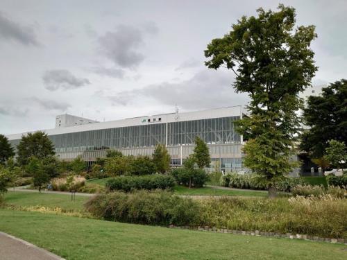 a large white building with a tree in front of it at HOTEL TETORA ASAHIKAWA EKIMAE - Vacation STAY 91497v in Asahikawa