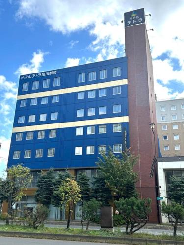 a large building with a clock tower in front of it at HOTEL TETORA ASAHIKAWA EKIMAE - Vacation STAY 91497v in Asahikawa