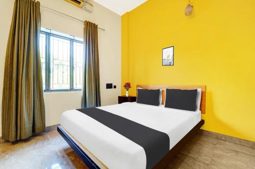 Ένα ή περισσότερα κρεβάτια σε δωμάτιο στο Super Hotel O Thrissur Near Thrissur Medical College