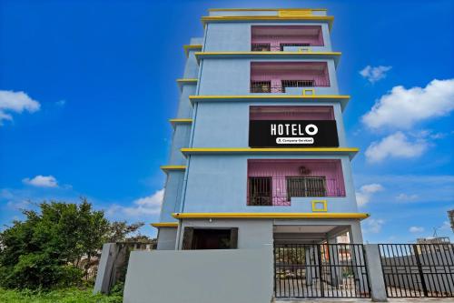 a tall blue building with a hotel sign on it at Hotel O Uniworld Formerly Cubic Palace in kolkata