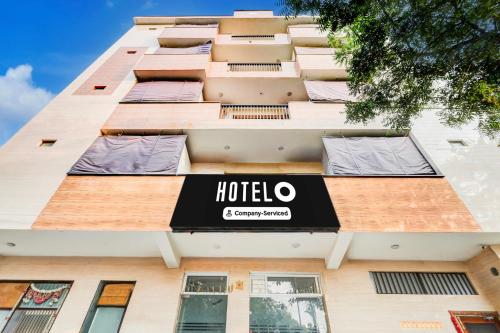 a hotel sign on the side of a building at Super Hotel O Sector 25 Near Iskcon Temple Formerly Hotel Amazing House in New Delhi