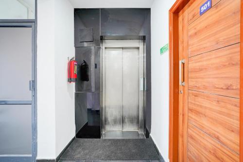 a hallway with a metal elevator in a building at Super Townhouse Jeevan Bima Nagar Indranagar in Bengaluru