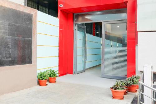 an entrance to an office building with potted plants at Super Townhouse Jeevan Bima Nagar Indranagar in Bengaluru