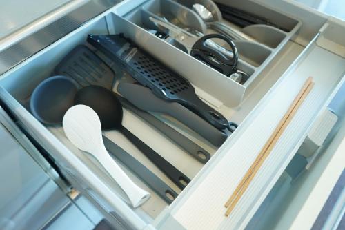 a drawer filled with cooking utensils and other kitchen items at COCO VILLA 南房総 Dog Stay in Minamiboso