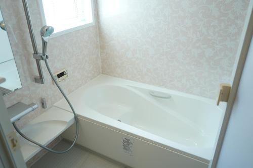a bathroom with a shower and a white tub at COCO VILLA 南房総 Dog Stay in Minamiboso