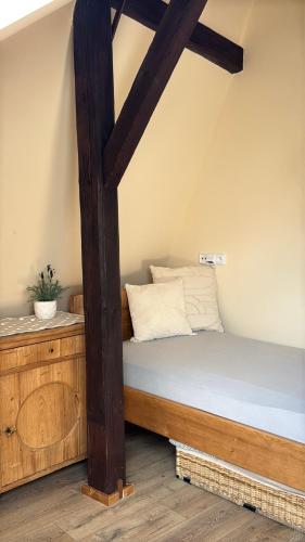 a bed with a wooden frame in a room at U Anny Šmejdířky in Nymburk