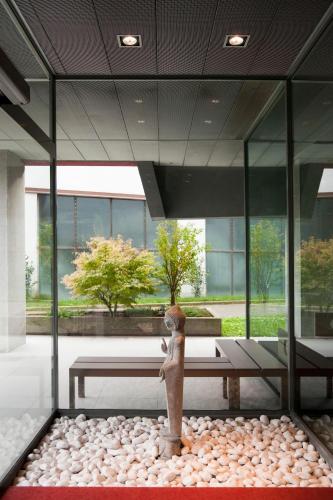 a statue in the middle of a room with windows at Zambala Luxury Apartments in Milan