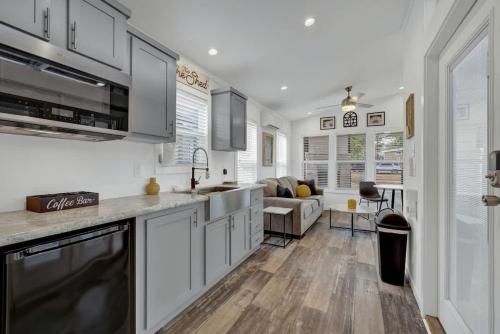 a kitchen with white cabinets and a living room at Resort at Fredericksburg Unit 25 in Rocky Hill
