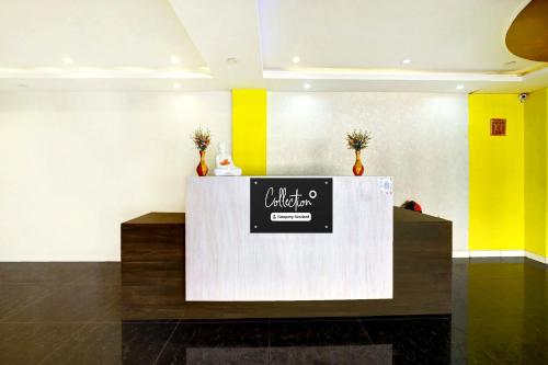 a lobby with a counter with a sign on it at Super Collection O Hassan Industrial Area formerly Sagayi Resort in Hassan