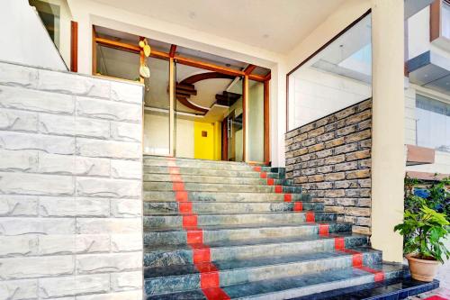 a set of stairs in front of a building at Super Collection O Hassan Industrial Area formerly Sagayi Resort in Hassan