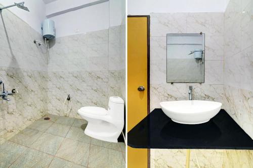 a bathroom with a white toilet and a sink at Super Collection O Hassan Industrial Area formerly Sagayi Resort in Hassan