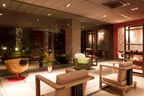 a lobby with chairs and furniture in a building at Zambala Luxury Apartments in Milan