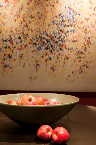 a bowl of apples on a table next to a painting at Zambala Luxury Apartments in Milan