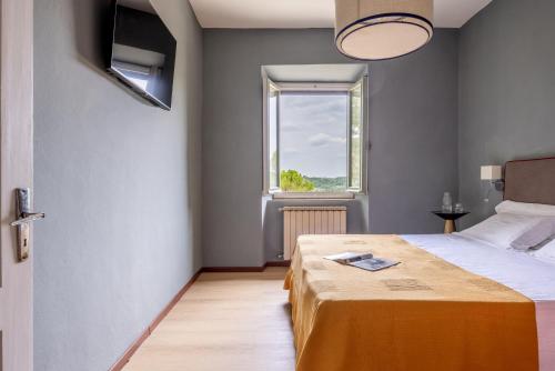 Postel nebo postele na pokoji v ubytování Relais Badia a Passignano