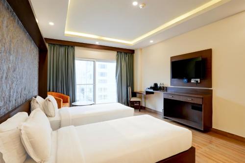 Super Townhouse Oak Mahadevapura Opposite Phoenix Mall Formerly Grand Wilton Innにあるベッド