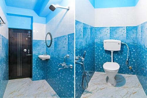 a blue bathroom with a toilet and a shower at Super Hotel O Kabardanga More Kolkata Formerly Royal Crown Banquet in Taliganja
