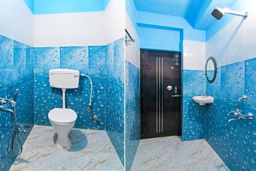 a blue bathroom with a toilet and a sink at Super Hotel O Kabardanga More Kolkata Formerly Royal Crown Banquet in Taliganja