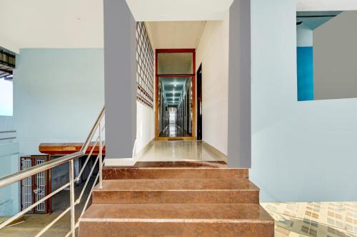 a staircase leading to a building with a door at Super Hotel O Okkilipalayam in Coimbatore