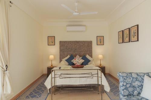 a bedroom with a bed and a couch at Ramathra Fort in Sapotra