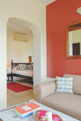 a living room with a couch and a table at Ramathra Fort in Sapotra