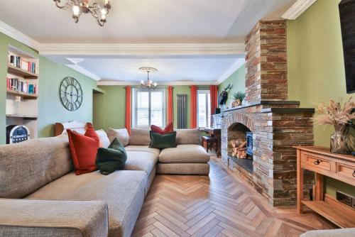 a living room with a couch and a fireplace at The Family Nest – Swansea 4 Bedroom Retreat in Swansea