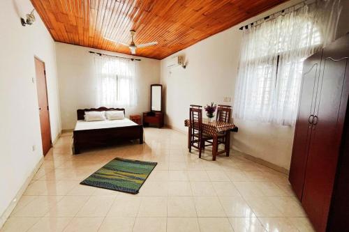 a bedroom with a bed and a wooden ceiling at Tree Breeze in Negombo