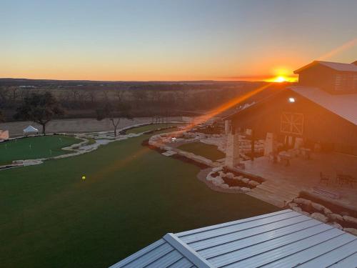 an aerial view of a barn with the sunset in the background at Resort at Fredericksburg Unit 24 in Rocky Hill
