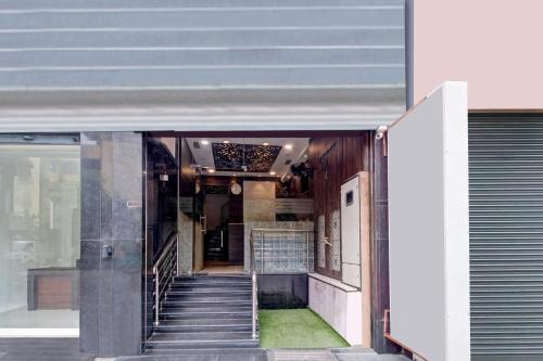 a staircase leading up to a building with a door at Hotel O Vijayawada Near Railway Station in Vijayawāda
