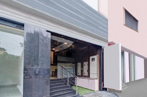 an open door to a building with a staircase at Hotel O Vijayawada Near Railway Station in Vijayawāda