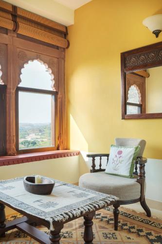a room with a table and a chair and a window at Ramathra Fort in Sapotra