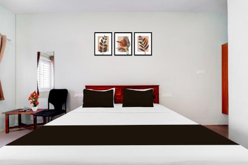 a bedroom with a large bed and a chair at Super Collection O Karumathampatti in Coimbatore
