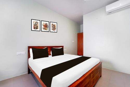 a bedroom with a large bed in a room at Super Collection O Karumathampatti in Coimbatore