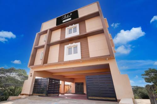 a building with two garage doors in front at Super Collection O Karumathampatti in Coimbatore