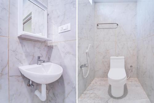 a white bathroom with a sink and a toilet at Super Collection O Karumathampatti in Coimbatore