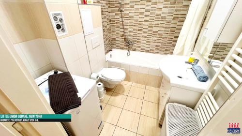 a small bathroom with a toilet and a sink at Little New York West Side Apartments in Budapest