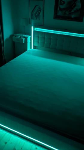 a bedroom with a bed with a blue light at Il Giardino dell'Eden in Caprile