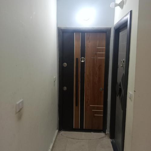 a hallway with a wooden door in a room at Hurghada City apartments Red sea in Hurghada