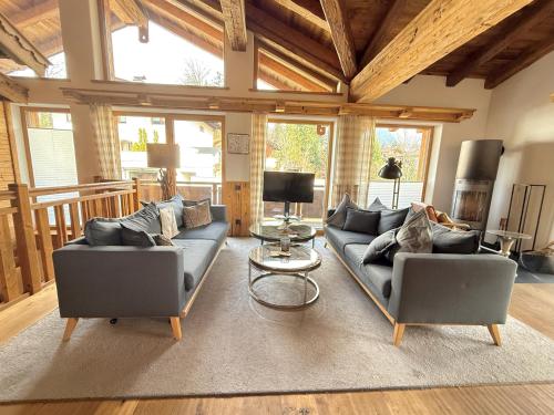 a living room with two couches and a table at CHALET BELLE KAISER by Belle Stay in Going
