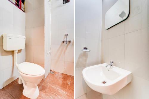 a bathroom with a toilet and a sink at Super Collection O Kottayam Formerly Sap Inn in Kottayam