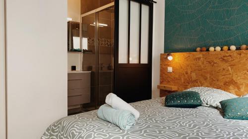 ニオールにあるLa maison d'Angélique - Colocation hôtelière à 150m Gare TGV- Grande cuisine équipée & salon - Fibre - Netflixの枕が置かれたベッドのある寝室