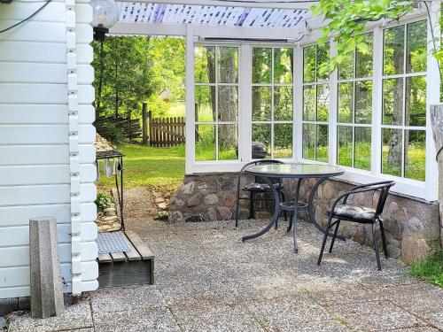 a patio with a table and chairs in front of a house at 3 person holiday home in VÄSTERVIK-By Traum in Västervik