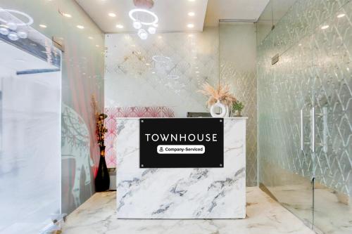 a room with a table with a sign on it at Super Townhouse Faridabad Railway Station Formerly Hotel Royals Paradaise in Faridabad