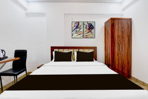 a bedroom with a bed and a desk at Super Collection O Hinjewadi Phase 1 Formerly Mars Venture in Hinjewadi