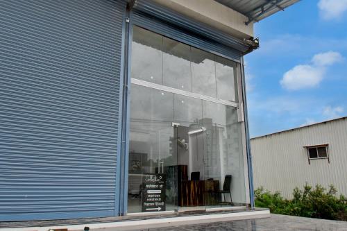 a glass window of a building with books in it at Super Collection O Hinjewadi Phase 1 Formerly Mars Venture in Hinjewadi
