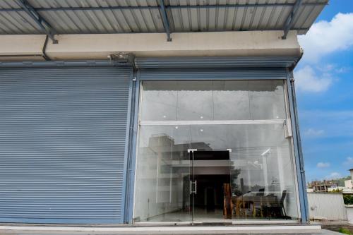 a large glass window in a building with a door at Super Collection O Hinjewadi Phase 1 Formerly Mars Venture in Hinjewadi