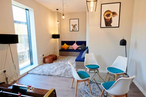 a living room with chairs and a bed in the background at Student Only Canvas Walthamstow in London in London