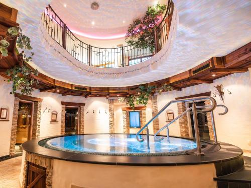 a large pool of water in a large building at Alpenhotel Tirolerhof in Neustift im Stubaital